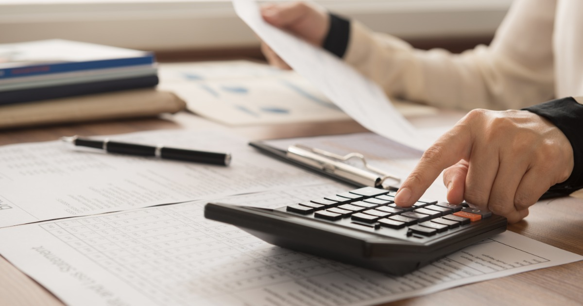 Labor union staff reviewing financial records and calculations for LM-2 preparation