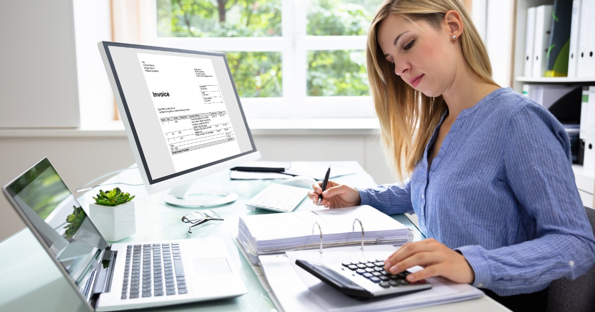 Financial administrator reviewing invoices, calculating payments, and organizing financial records to support accurate union financial reporting.